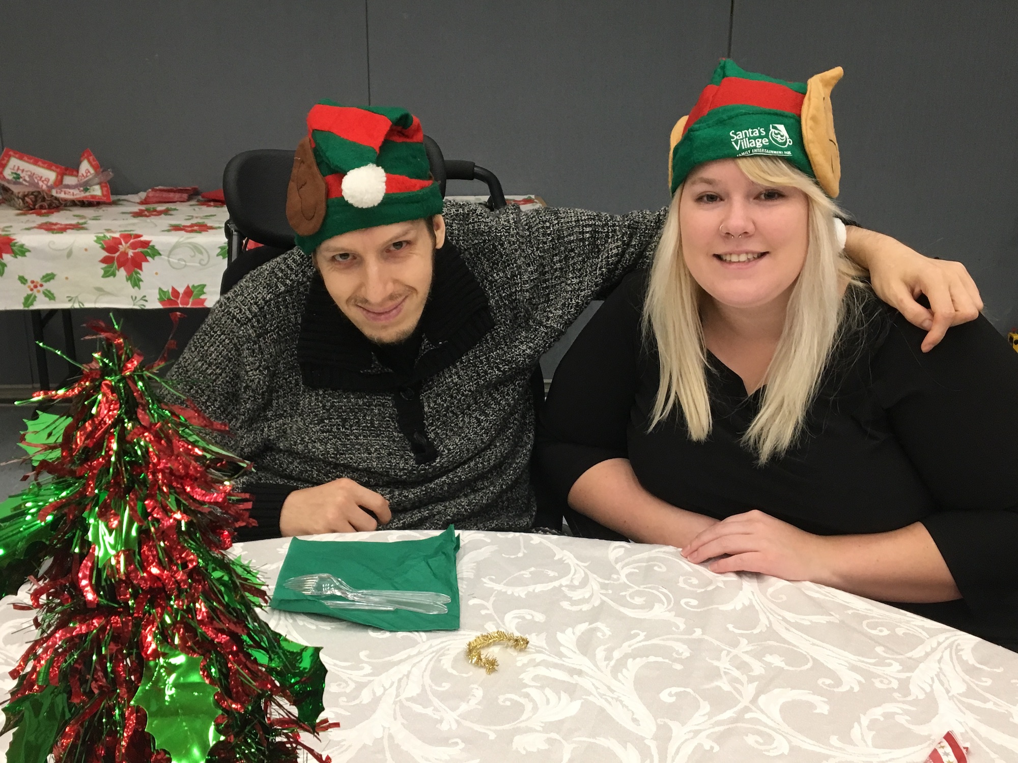 two people wearing christmas hats