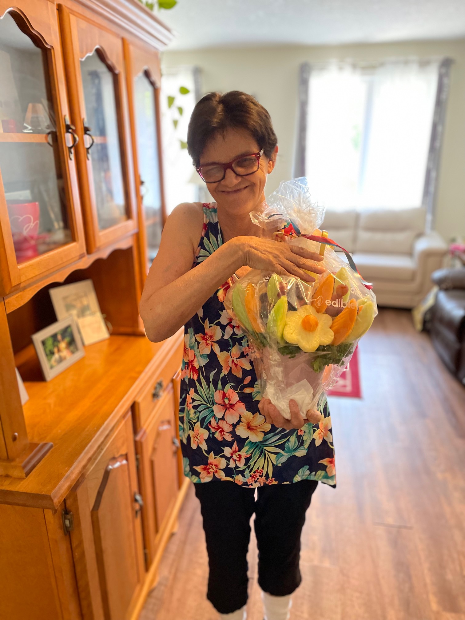 smiling woman with fruit arrangement