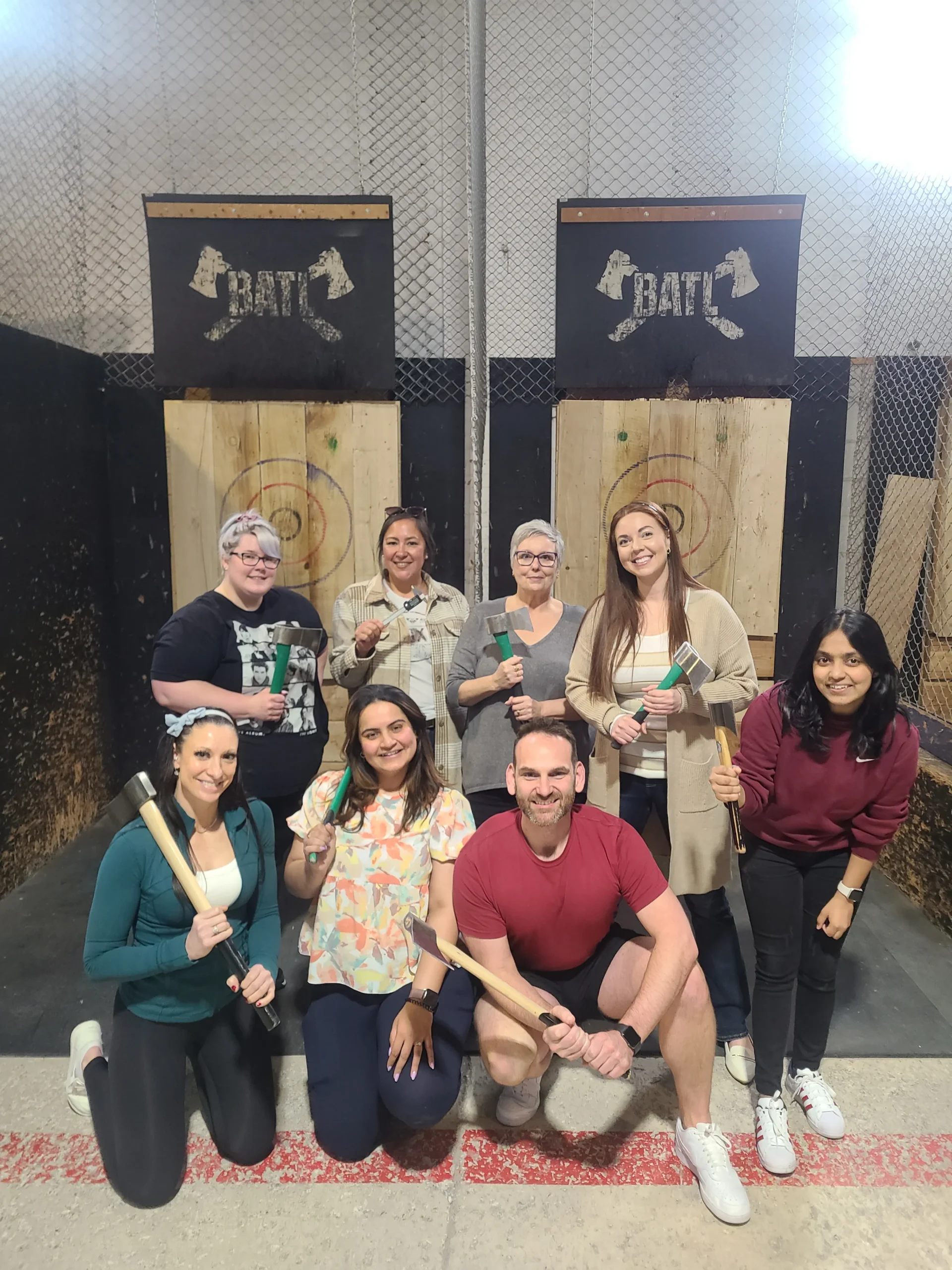 A group picture of Forward House of London staff at the end of a axe throwing event.